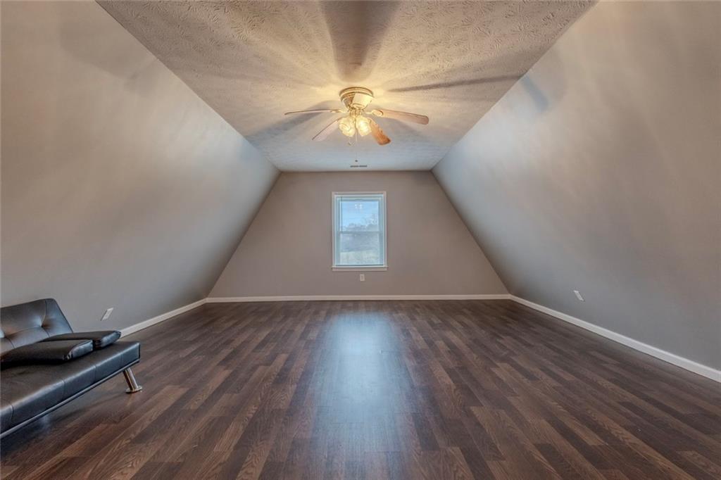160 Highway 320 Carnesville, GA 30521 - Photo 35 of 68 an empty room with wooden floor chandelier fan and windows