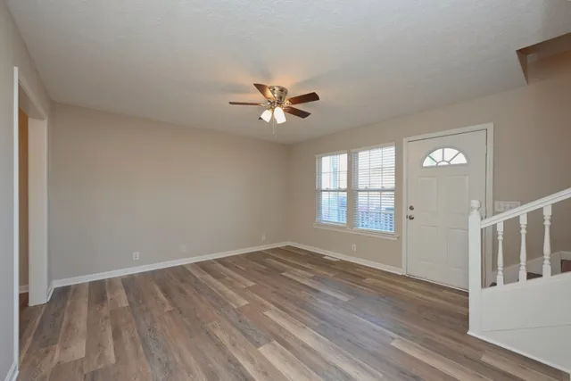 wooden floor in an empty room with a window