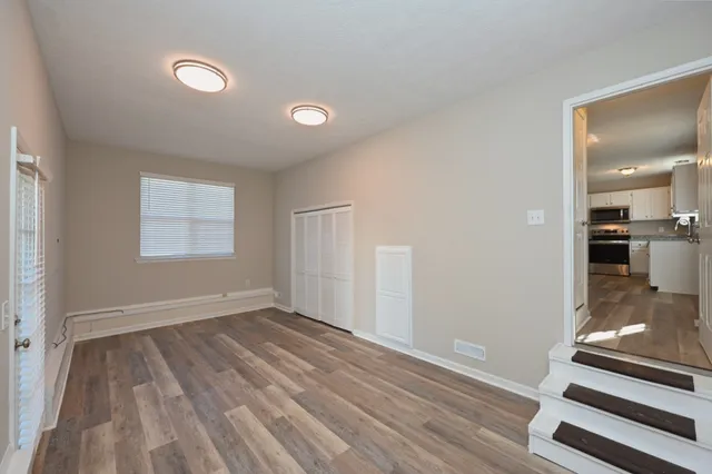 wooden floor in an empty room with a window