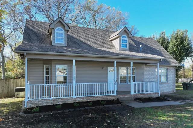 a view of a house with a window and wooden fence