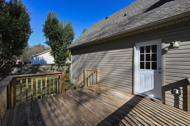 a view of house with deck and outdoor seating