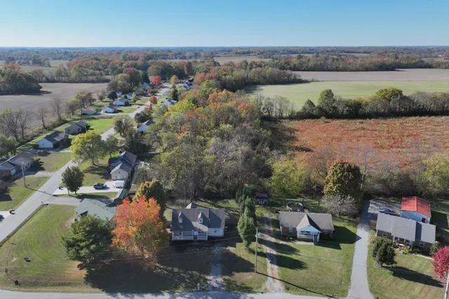 an aerial view of a house with a lake view