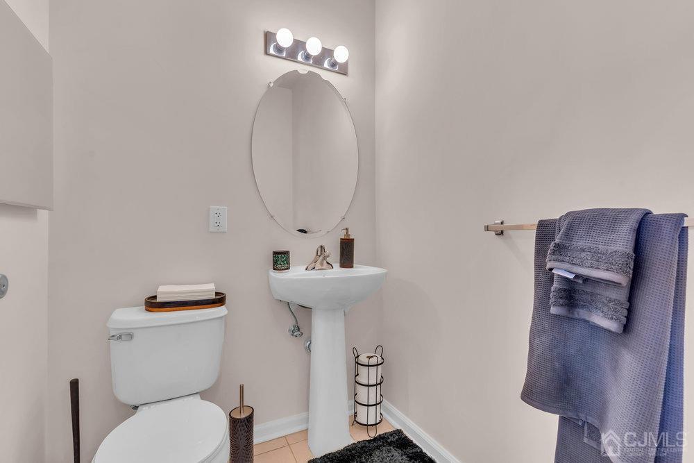 368 Rector Street, Unit 508 Perth Amboy, NJ 08861 - Photo 14 of 34 a bathroom with a toilet a sink and mirror