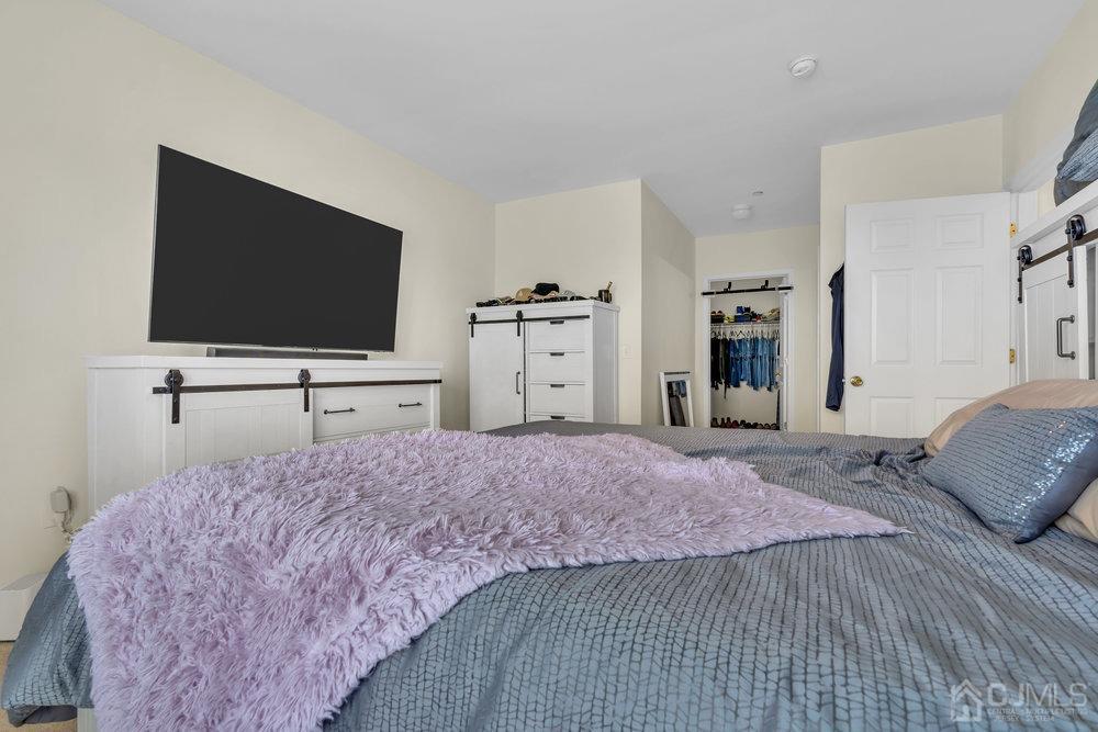 368 Rector Street, Unit 508 Perth Amboy, NJ 08861 - Photo 17 of 34 a bedroom with a bed and a flat screen tv