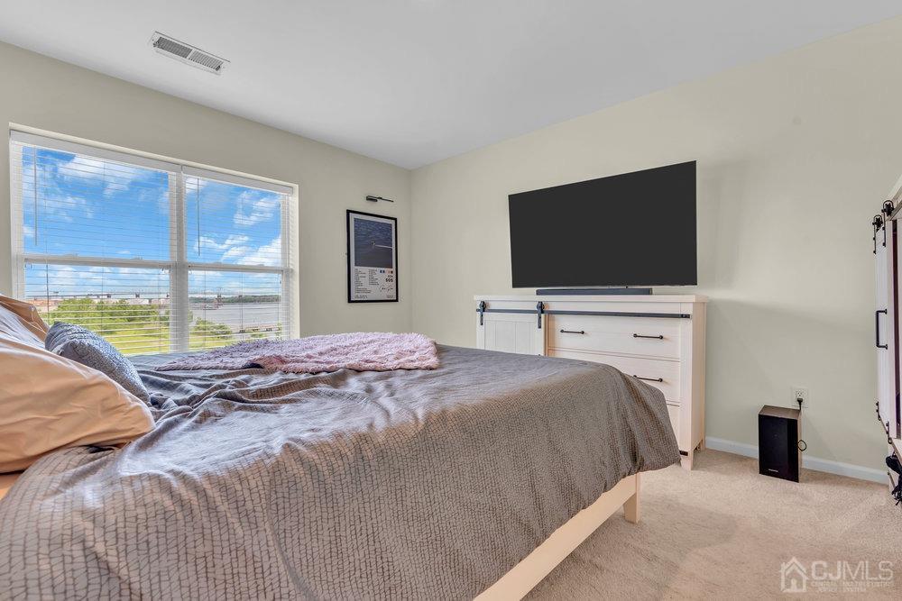 368 Rector Street, Unit 508 Perth Amboy, NJ 08861 - Photo 19 of 34 a bedroom with a bed and a flat screen tv