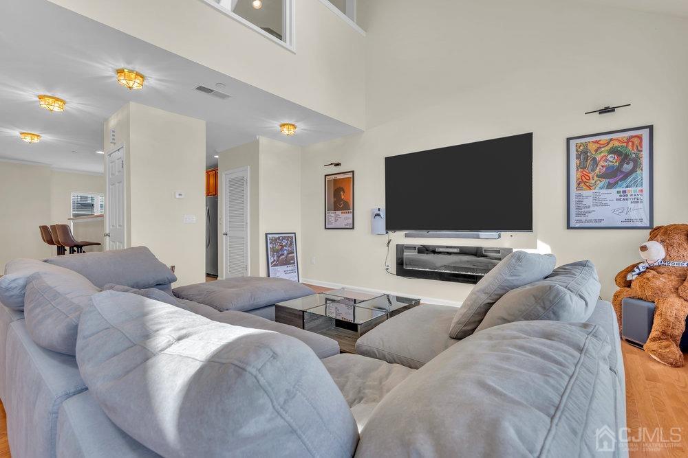 368 Rector Street, Unit 508 Perth Amboy, NJ 08861 - Photo 2 of 34 a living room with furniture and a flat screen tv
