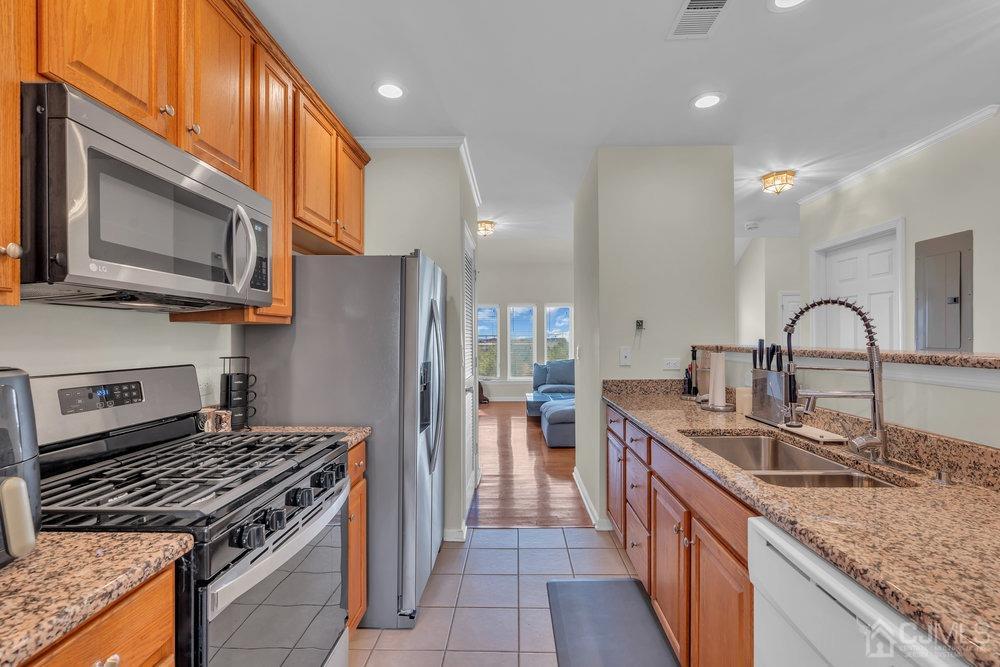 368 Rector Street, Unit 508 Perth Amboy, NJ 08861 - Photo 29 of 34 a kitchen with stainless steel appliances granite countertop a sink stove and refrigerator