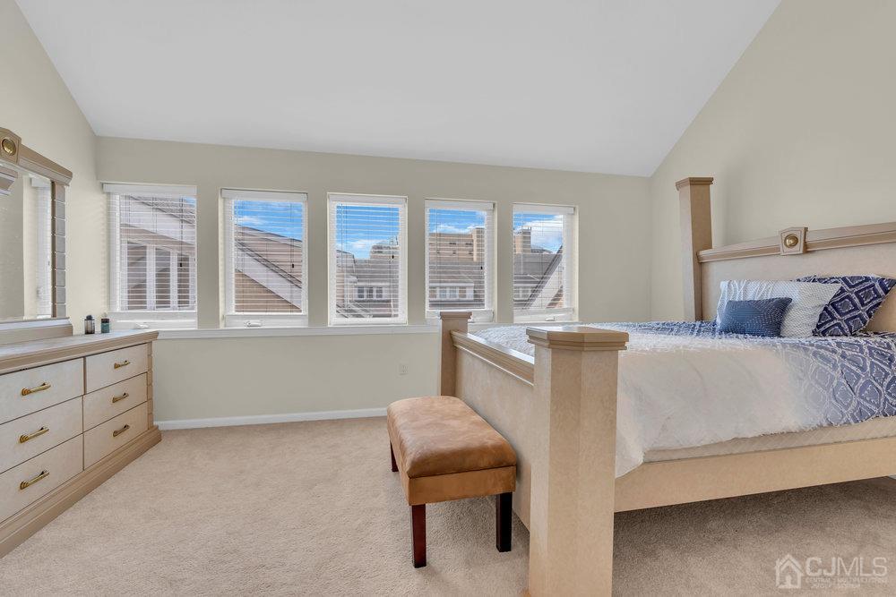 368 Rector Street, Unit 508 Perth Amboy, NJ 08861 - Photo 9 of 34 a bed room with a bed and a chair