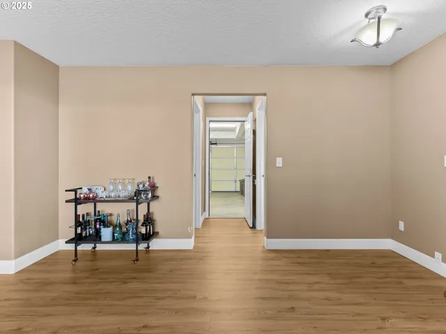 a view of a room with wooden floor and lounge chair