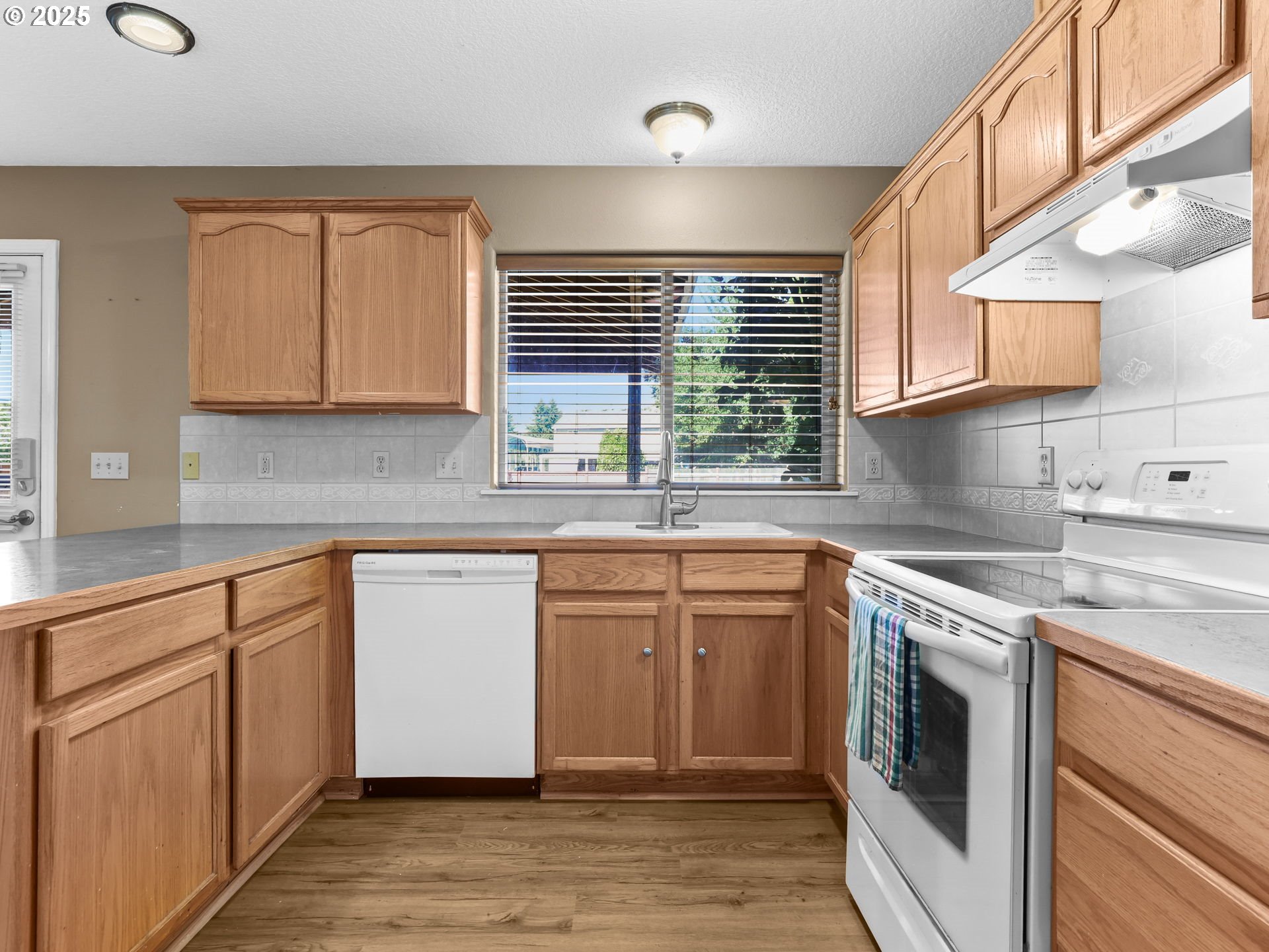 52407 Northeast 14th Scappoose, OR 97056 - Photo 7 of 46 a kitchen with stainless steel appliances granite countertop a sink a stove and cabinets