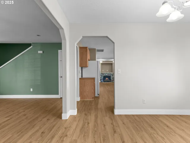 a view of a room with wooden floor