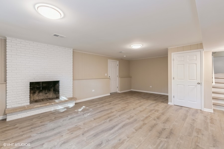 560 Linden Road Frankfort, IL 60423 - Photo 13 of 15 an empty room with wooden floor fireplace and windows