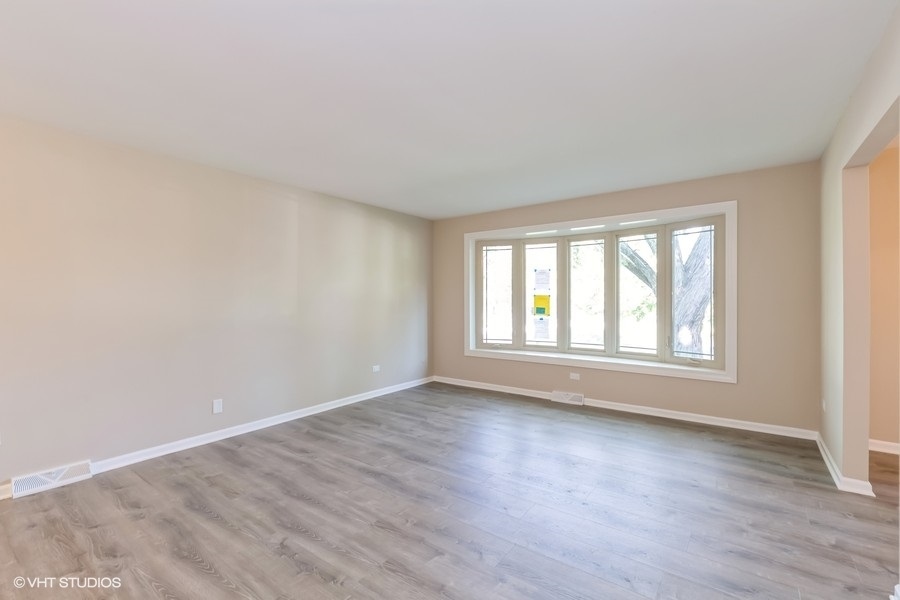 560 Linden Road Frankfort, IL 60423 - Photo 2 of 15 a view of an empty room with wooden floor and a window