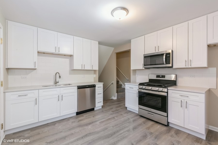 560 Linden Road Frankfort, IL 60423 - Photo 5 of 15 a kitchen with stainless steel appliances granite countertop a stove a sink and a microwave