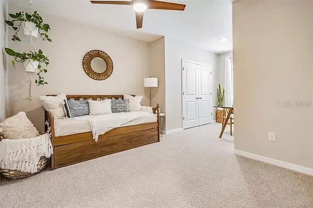 a bedroom with a bed and a lamp