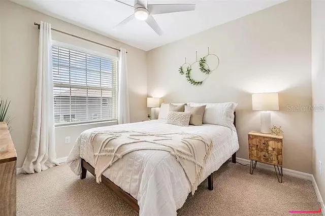 a bedroom with a bed and a painting on the wall