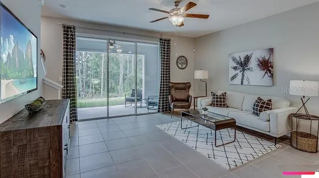a living room with furniture and a large window