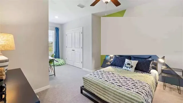 a bedroom with a bed and a potted plant