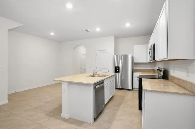 a kitchen with a sink stove and refrigerator