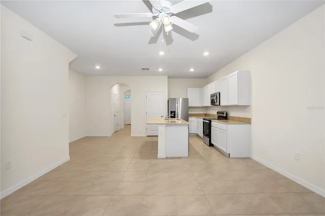 a view of kitchen with center island and stainless steel appliances