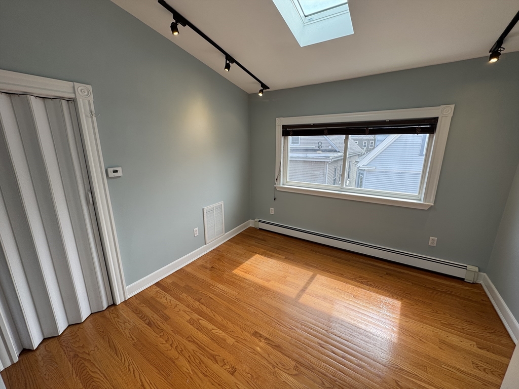 24 Ellington Road, Unit 3 Somerville, MA 02144 - Photo 12 of 21 a view of an empty room and window