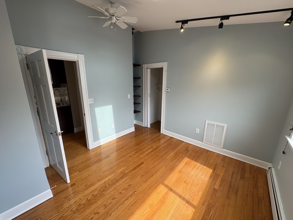 24 Ellington Road, Unit 3 Somerville, MA 02144 - Photo 14 of 21 a view of empty room with wooden floor
