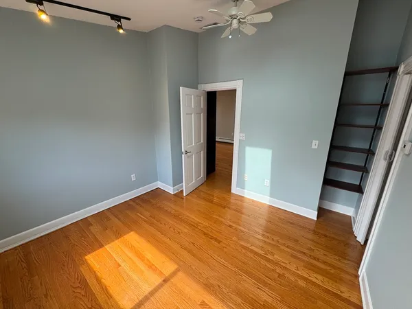 a view of walk in closet with empty racks
