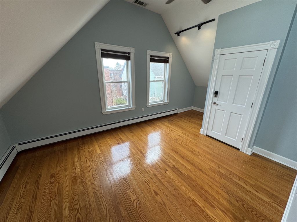 24 Ellington Road, Unit 3 Somerville, MA 02144 - Photo 18 of 21 a view of empty room with wooden floor and fan