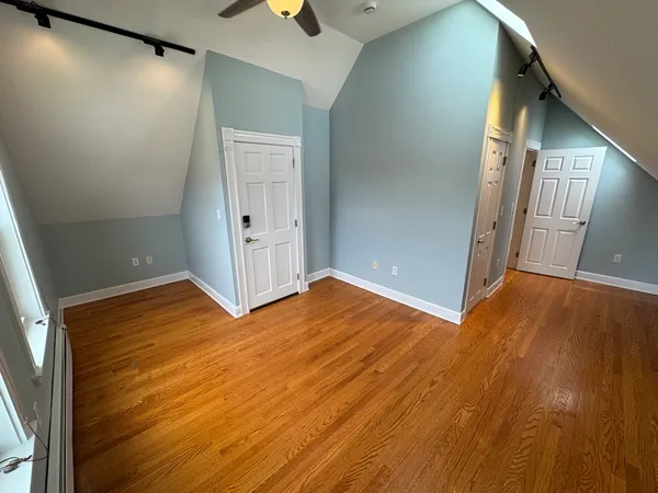 an empty room with wooden floor and closet