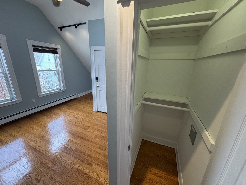 24 Ellington Road, Unit 3 Somerville, MA 02144 - Photo 21 of 21 a view of an empty room with wooden floor and a window