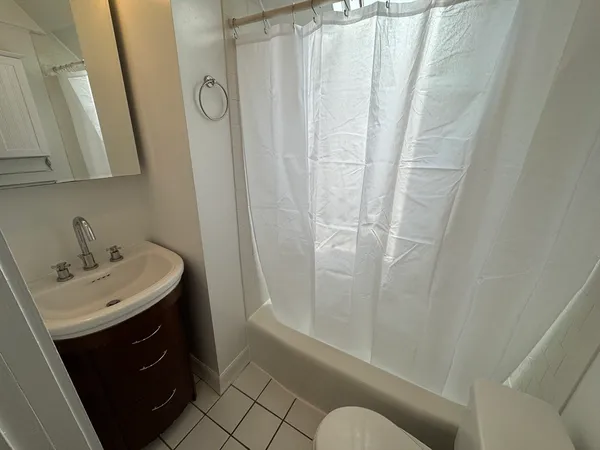 a bathroom with a sink a mirror a vanity and shower