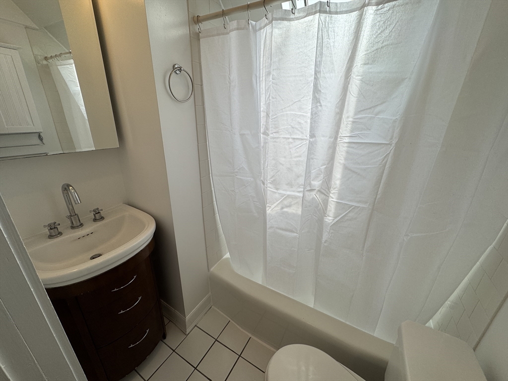 24 Ellington Road, Unit 3 Somerville, MA 02144 - Photo 9 of 21 a bathroom with a sink a toilet and shower