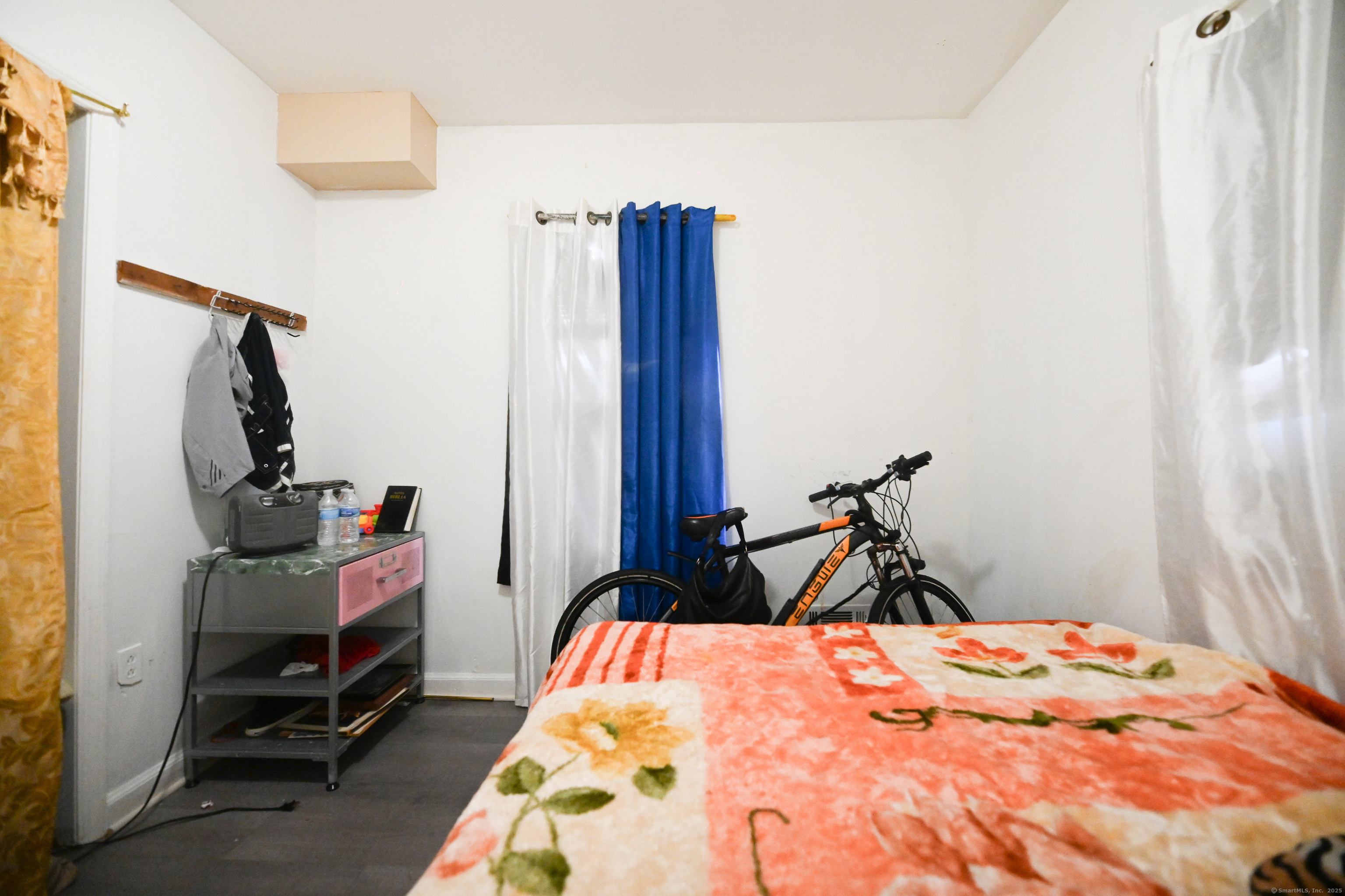 277 Helen Street Bridgeport, CT 06608 - Photo 16 of 19 a bedroom with a bed and wooden floor