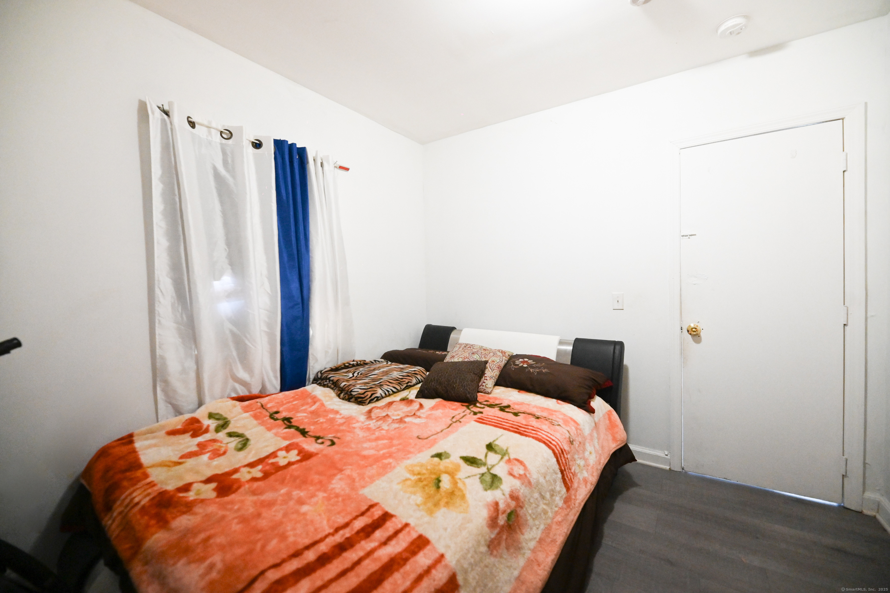 277 Helen Street Bridgeport, CT 06608 - Photo 17 of 19 a bed sitting in a bedroom next to a window