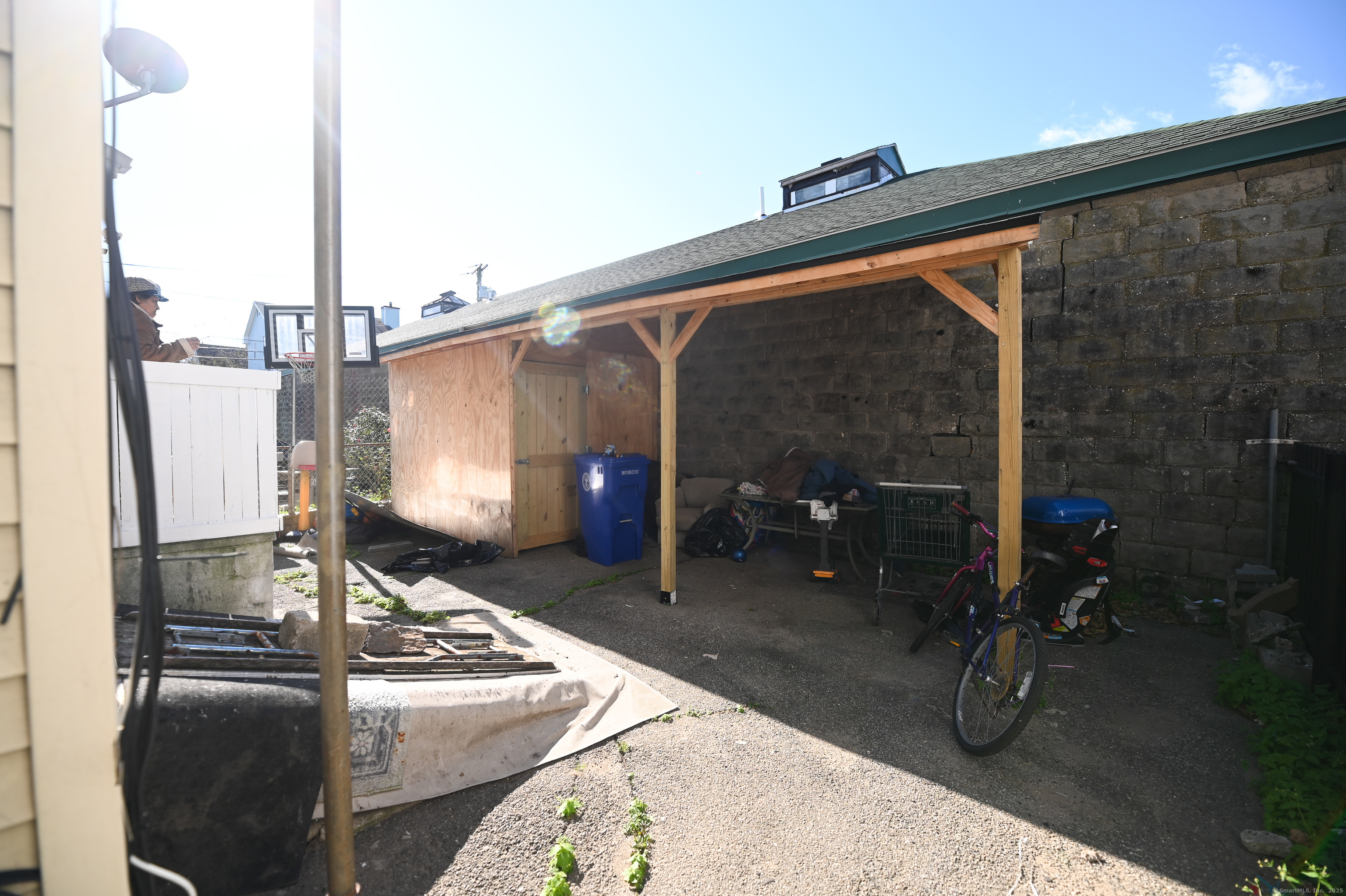 277 Helen Street Bridgeport, CT 06608 - Photo 19 of 19 a backyard of a house with barbeque oven table and chairs