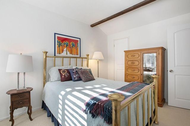 a bedroom with a bed and a lamp on table