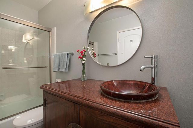 a bathroom with a sink a mirror and a toilet