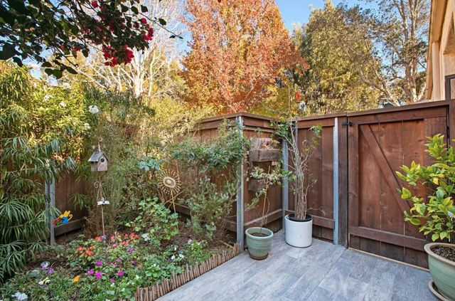 a view of a balcony with chair and potted plants
