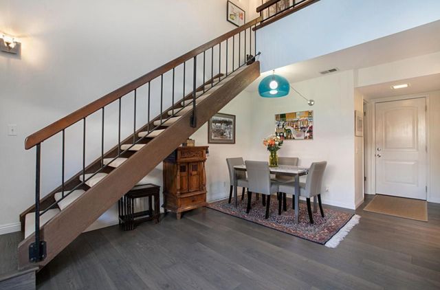 a dining room with furniture entryway and wooden floor