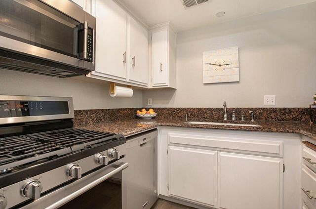 a stove top oven sitting inside of a kitchen