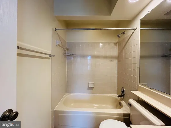 a bathroom with a tub and shower