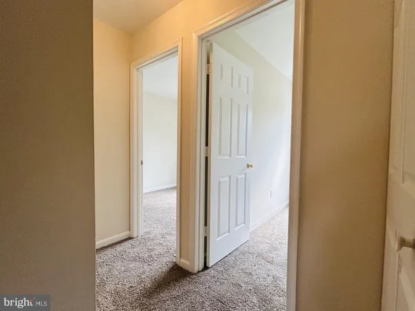 a view of a bathroom from a hallway