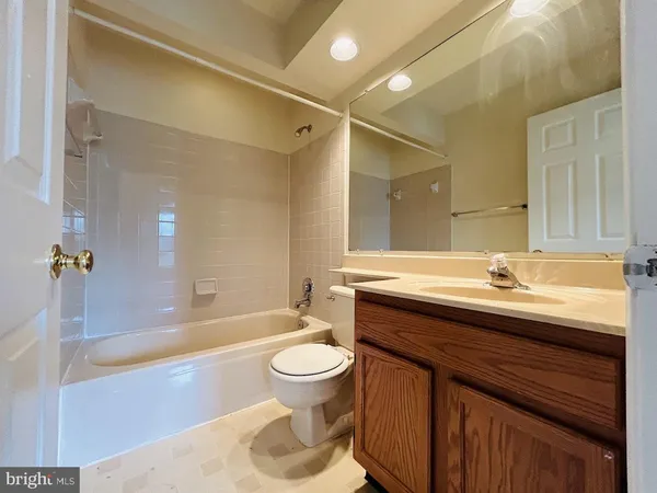a bathroom with a sink a toilet a mirror and bathtub