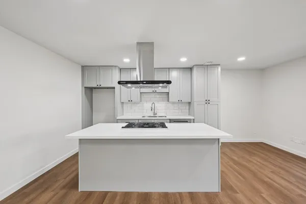a kitchen that has a sink a stove and a refrigerator