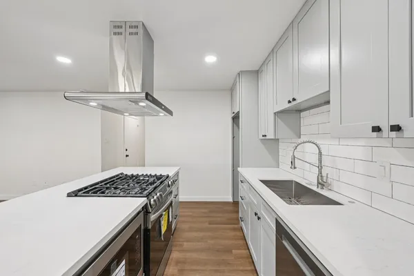 a kitchen that has a sink and a stove