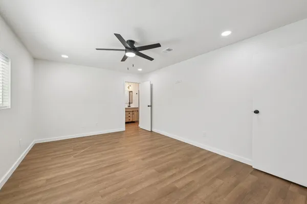 a view of an empty room with a ceiling fan