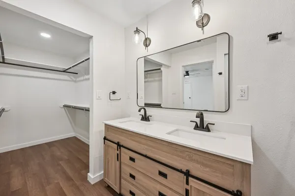 a view of closet with wooden floor