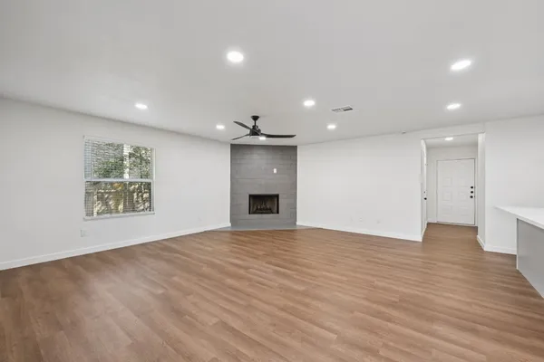 a view of kitchen with kitchen island wooden floor center island and appliances