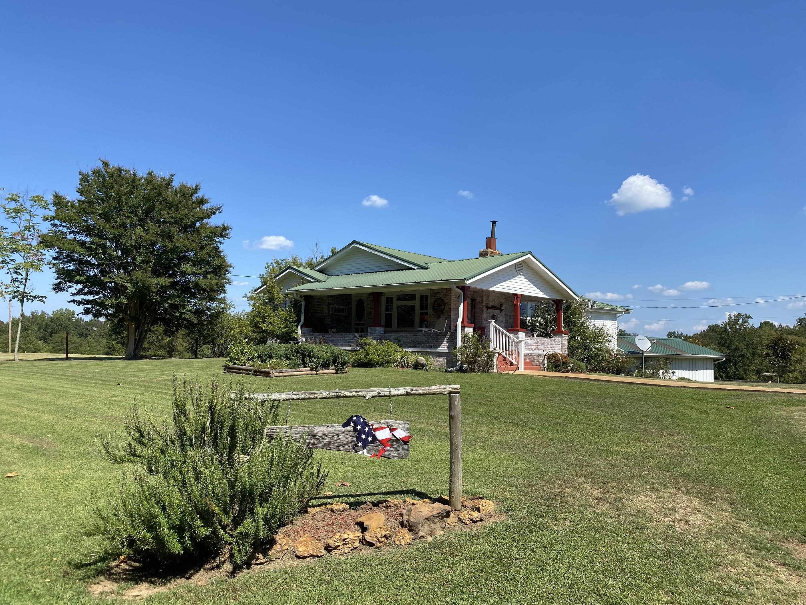 90 Dickson Road Sardis, TN 38371 - Photo 1 of 25 a front view of a house with garden