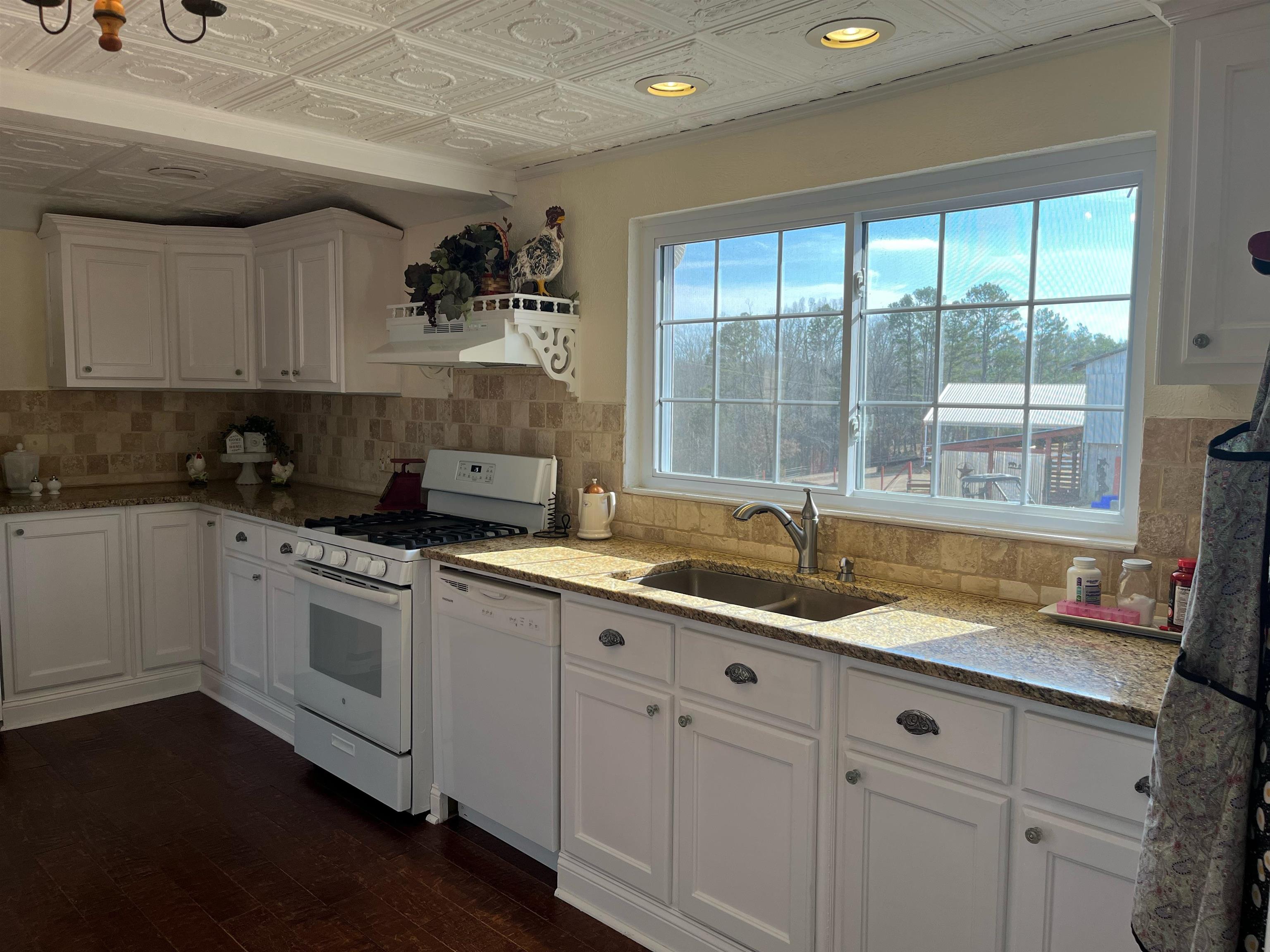 90 Dickson Road Sardis, TN 38371 - Photo 11 of 25 a kitchen with granite countertop a sink and white cabinets